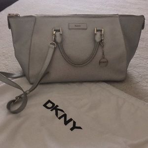 Sophisticated DKNY silver purse w gold accents.